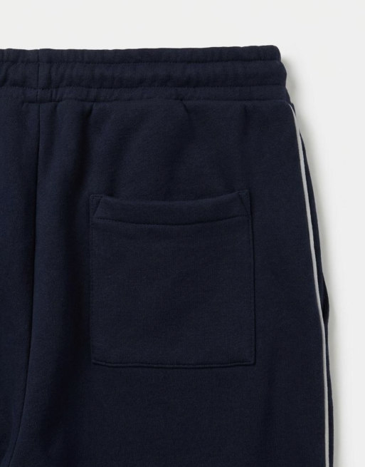 ASOS DESIGN – Superweite Jogginghose in Marineblau mit seitlicher Paspelierung, Kombiteil, 9 von 9