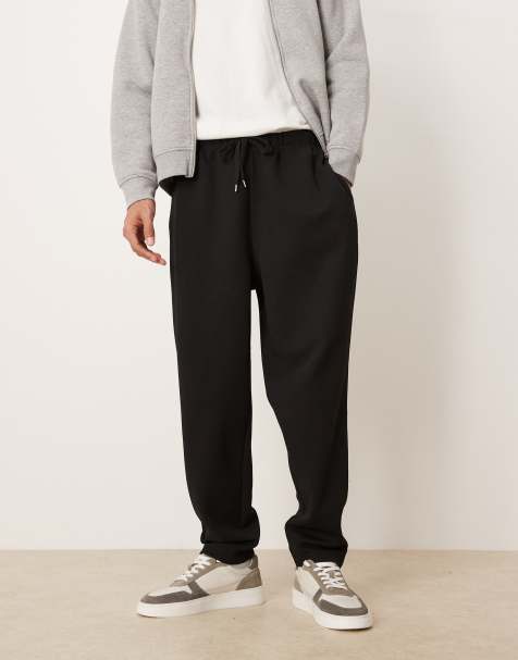 ASOS DESIGN – Svarta, avsmalnande mjukisbyxor med veck framtill - view 1