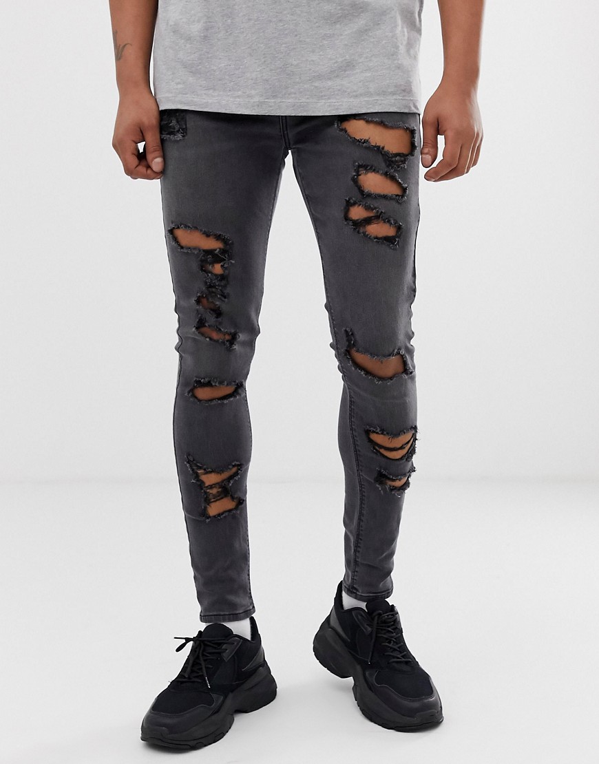 ASOS DESIGN – Svarta jeans i power-stretch med revor och spray on-passform