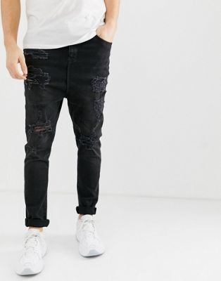 ASOS DESIGN – Svarta jeans med tvättad finish, låg gren och revor