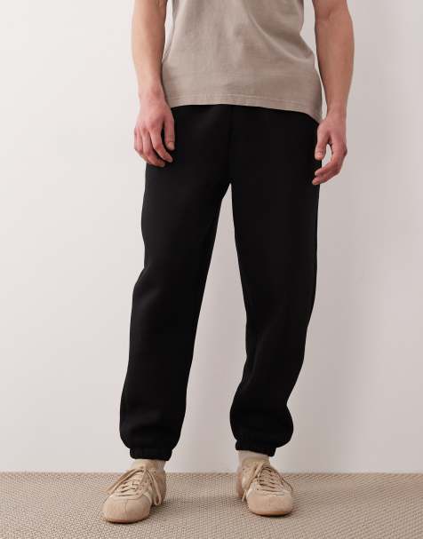 ASOS DESIGN – Svarta, kraftiga, avsmalnande mjukisbyxor i scubaliknande tyg - view 1