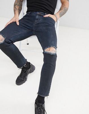 ASOS DESIGN – Svarta skinny jeans med knäslitningar och råskurna benslut