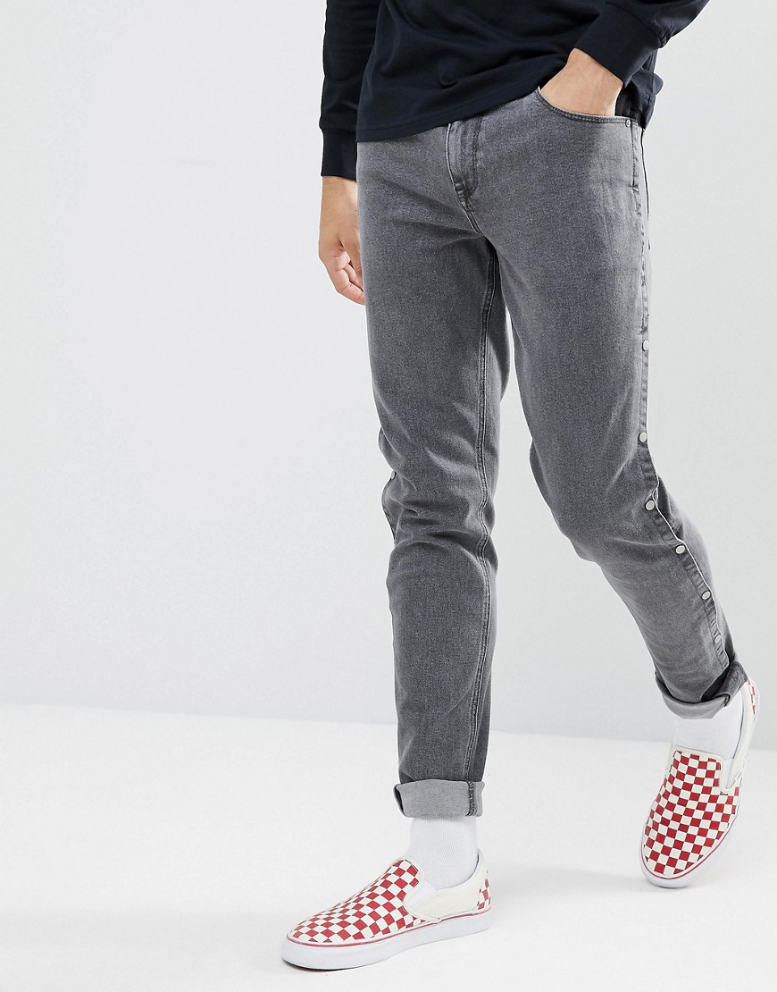 ASOS DESIGN – Svarta urtvättade skinny jeans med tryckknappar
