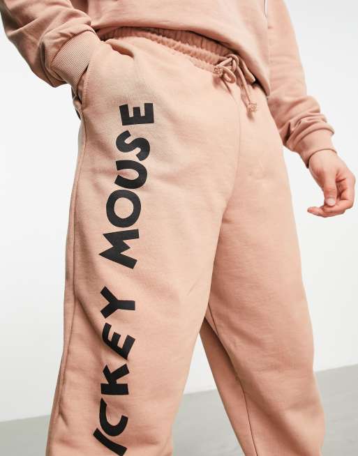 ASOS DESIGN sweatpants with Disney Mickey Mouse print in brown