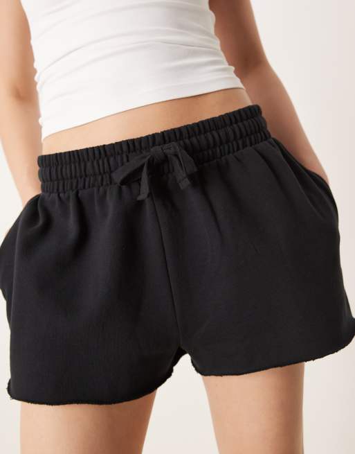 ASOS DESIGN sweatshirt fabric shorts with raw hem detail in black