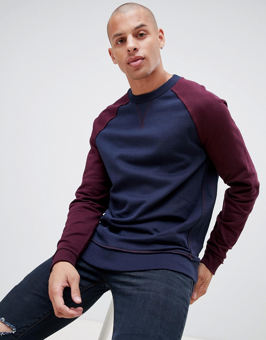 ASOS DESIGN - Sweatshirt met contrasterende raglanmouwen en onafgewerkte zomen-Marineblauw