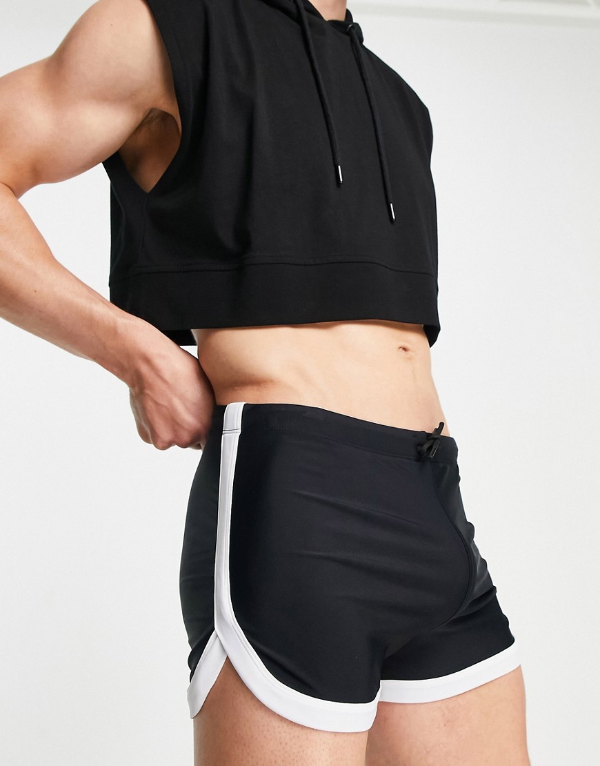ASOS DESIGN swim brief shorts with curved hem in black with white binding