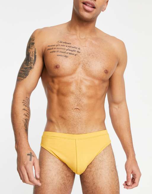 ASOS DESIGN swim briefs with textured rib in yellow