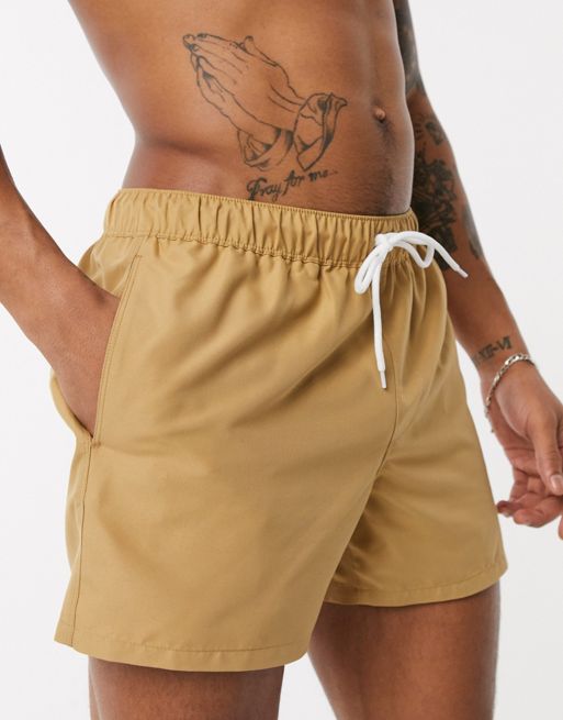 ASOS DESIGN swim shorts in short length in beige