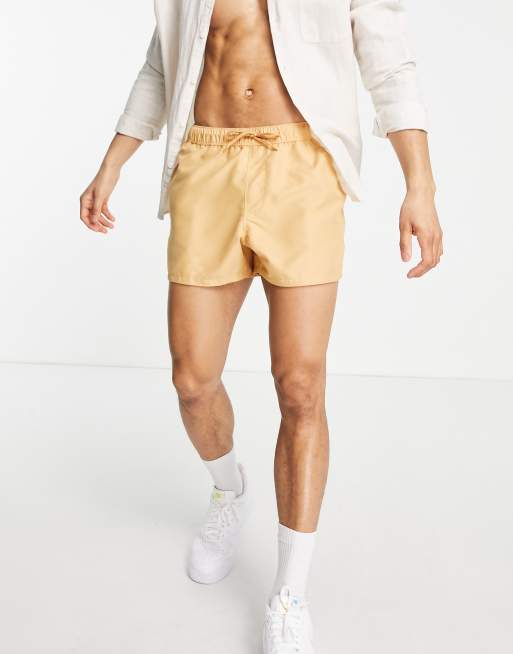 ASOS DESIGN swim shorts in short length in beige