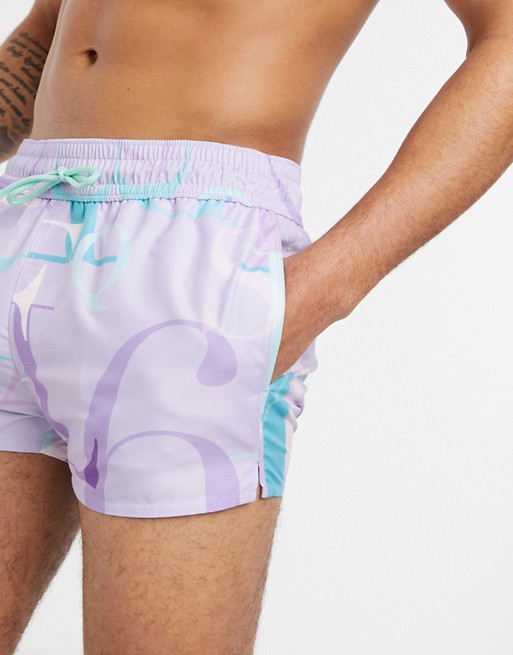 ASOS DESIGN swim shorts in lilac with slogan super short length
