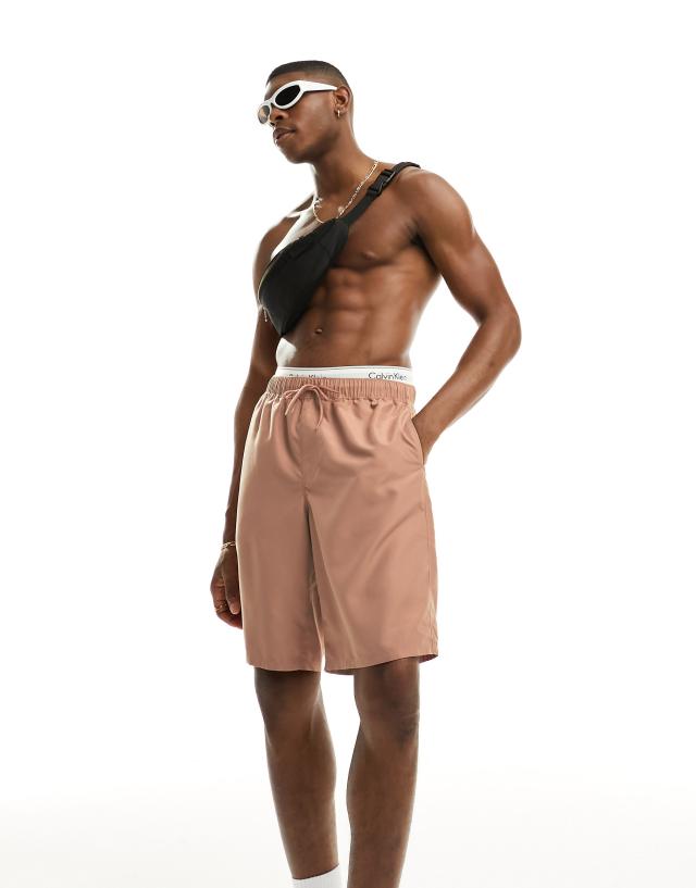 ASOS DESIGN swim shorts in long length in beige