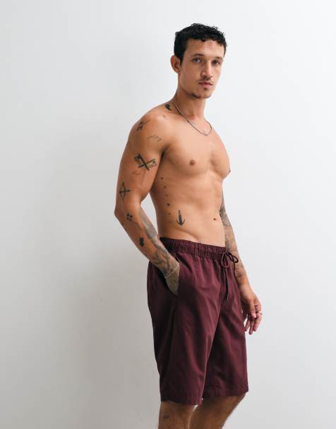 ASOS DESIGN swim shorts in long length in burgundy - view 1