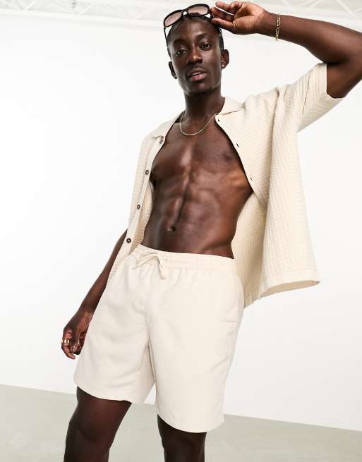 ASOS DESIGN swim shorts in short length in beige