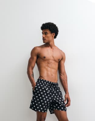 ASOS DESIGN swim shorts in mid length in black print