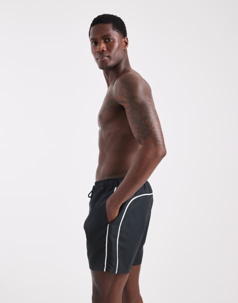 ASOS DESIGN swim shorts in mid length in black with contrast white binding