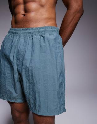 ASOS DESIGN swim shorts in mid length in blue-Green