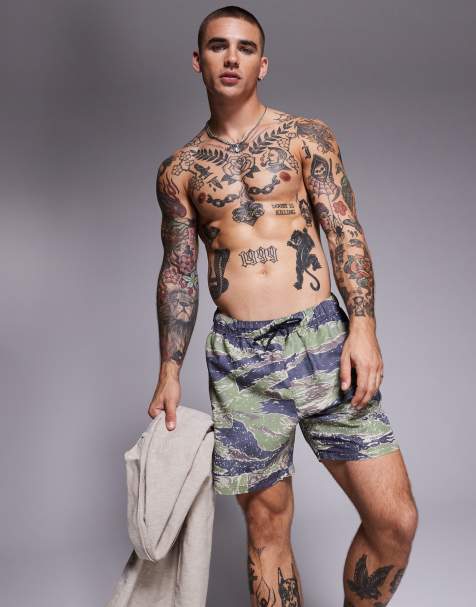ASOS DESIGN swim shorts in mid length in camouflage print in green - view 1