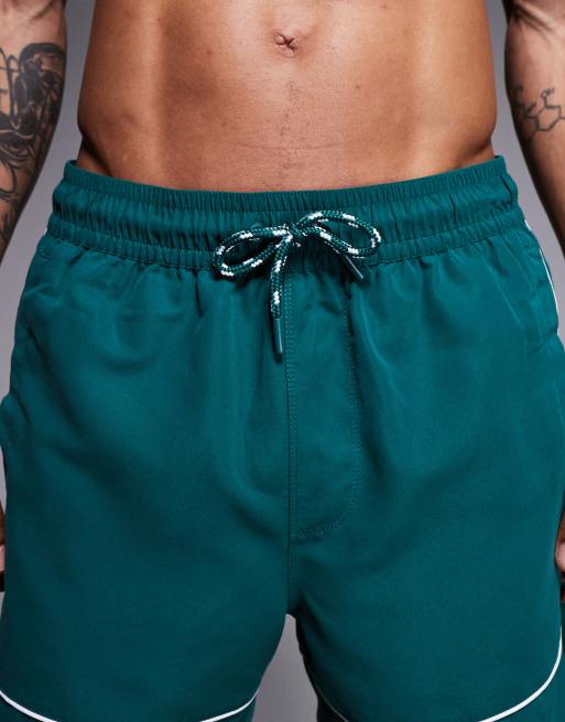 ASOS DESIGN swim shorts in mid length in dark green with contrast white binding, 4 of 5