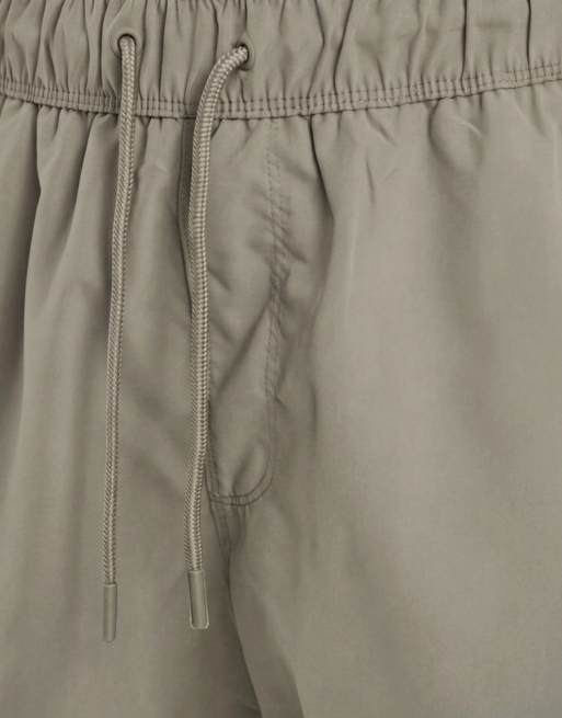 ASOS DESIGN swim shorts in mid length in khaki, 9 of 9