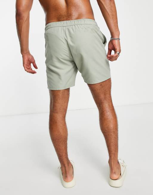 ASOS DESIGN swim shorts in short length with thick waistband in yellow