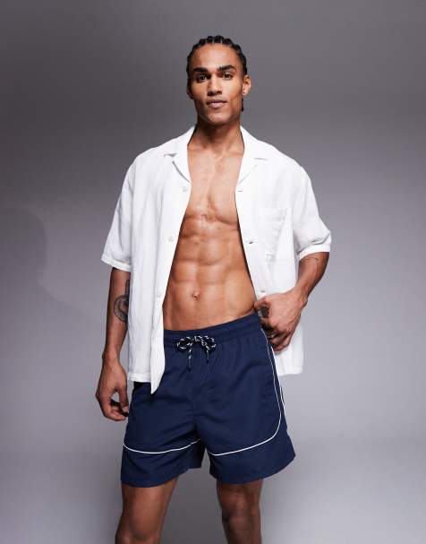 ASOS DESIGN swim shorts in mid length in navy with contrast white binding - view 1