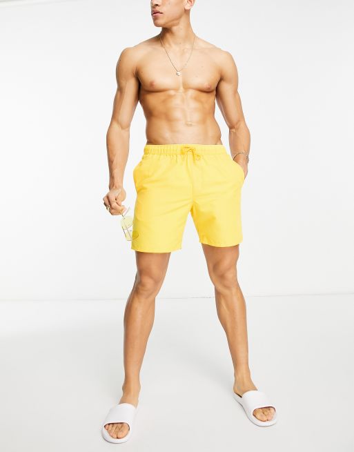 ASOS DESIGN swim shorts in short length with thick waistband in yellow