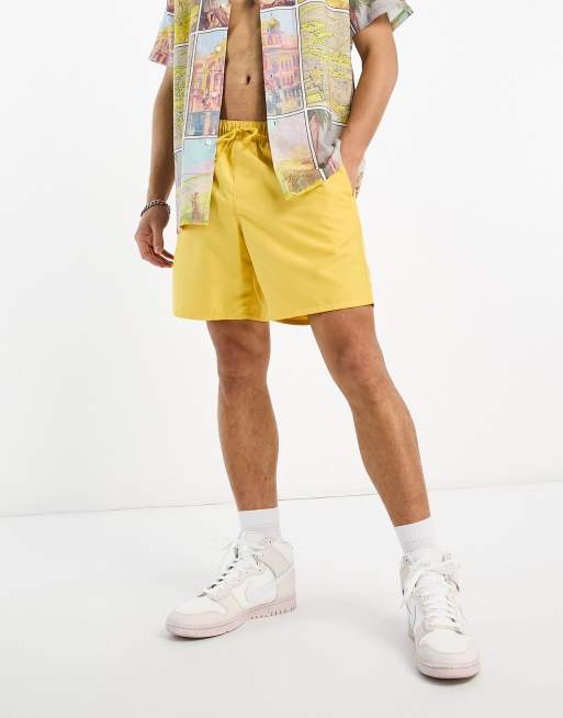 ASOS DESIGN swim shorts in short length with thick waistband in yellow