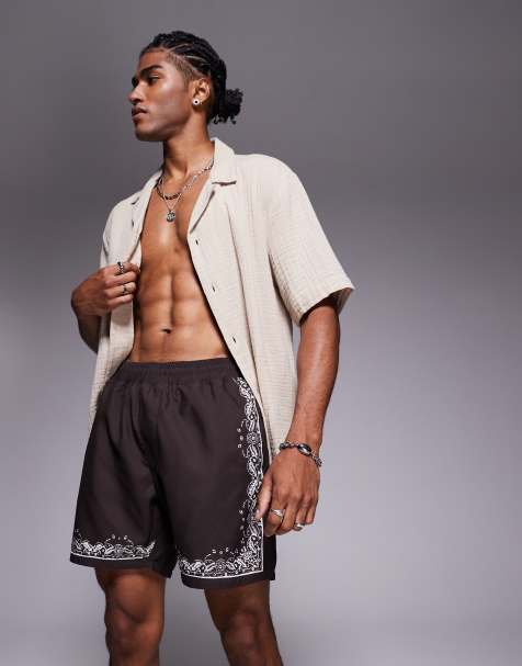 ASOS DESIGN swim shorts in mid length with border print in brown - view 1