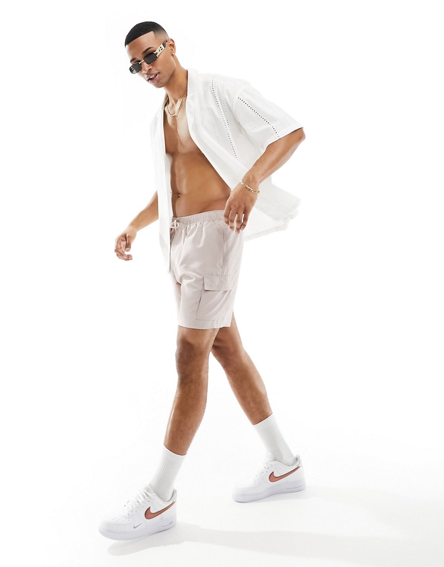 ASOS DESIGN swim shorts in mid length with cargo pockets in beige-Neutral