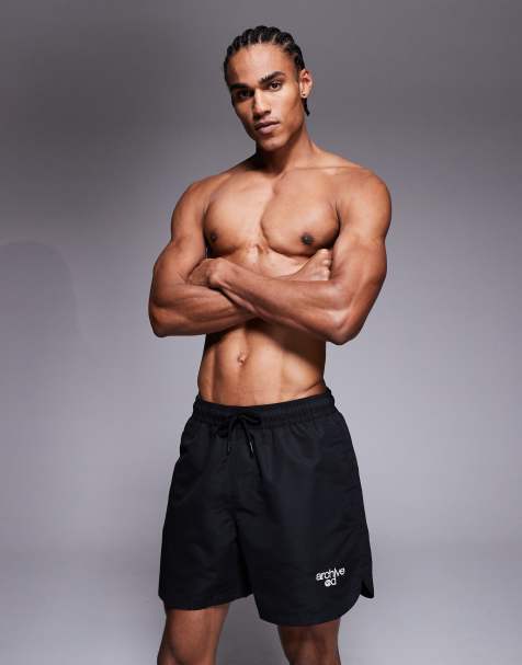 ASOS DESIGN swim shorts in mid length with embroidery in black