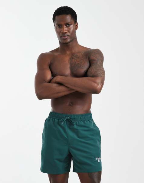 ASOS DESIGN swim shorts in mid length with embroidery in green - view 1
