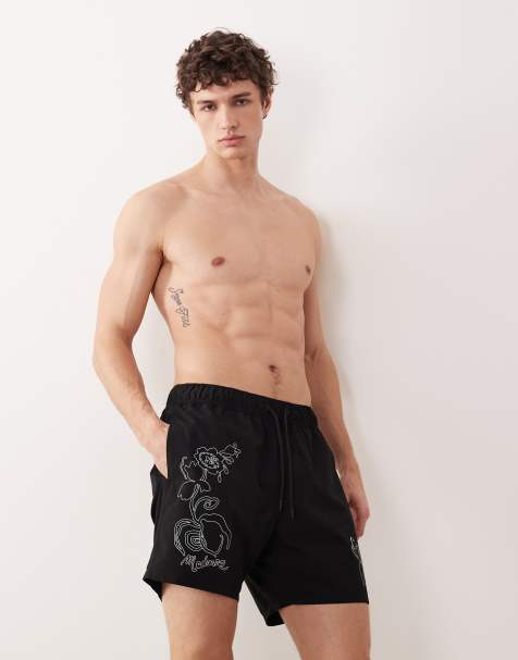 ASOS DESIGN swim shorts in mid length with floral placement print in black - view 1