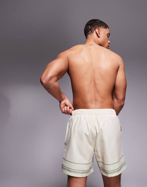 ASOS DESIGN swim shorts in mid length with placement print in beige