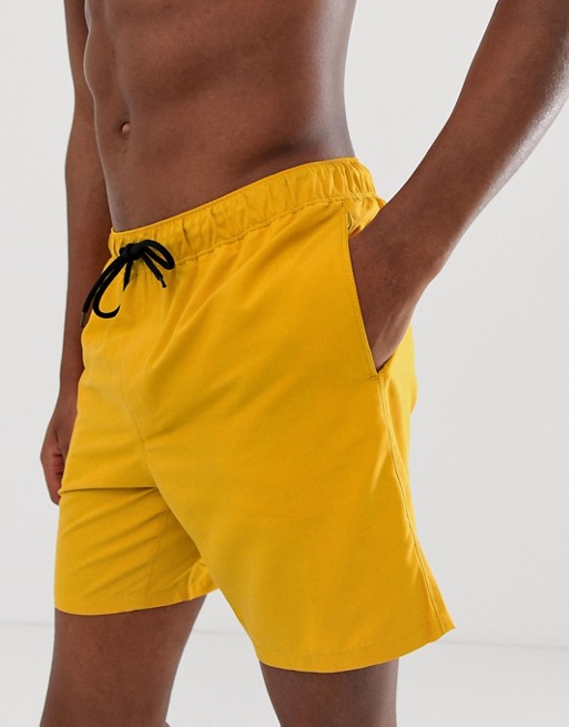 ASOS DESIGN swim shorts in mustard yellow in mid length | ASOS