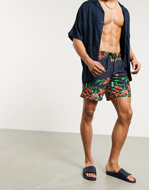 ASOS DESIGN swim shorts in navy with floral border print mid legnth
