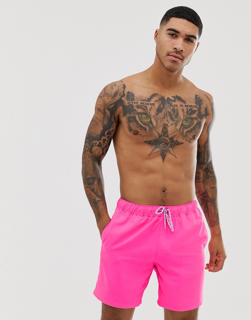 ASOS DESIGN swim shorts in neon pink in mid length