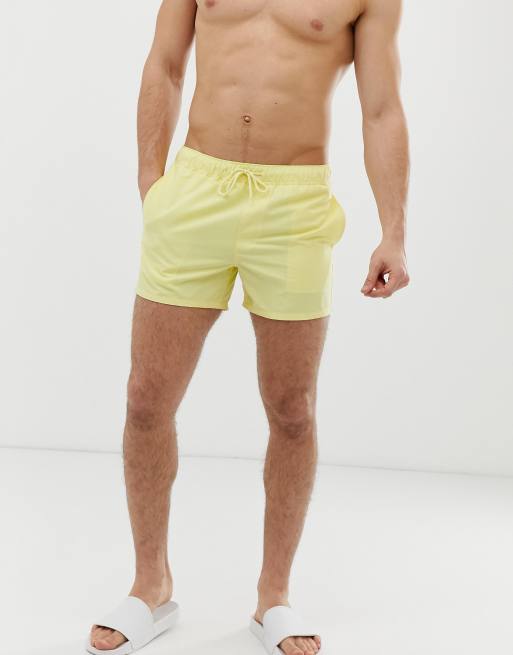 ASOS DESIGN swim shorts in pale yellow short length