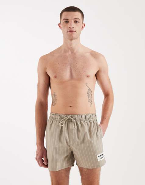 ASOS DESIGN swim shorts in short length in beige stripe with badge