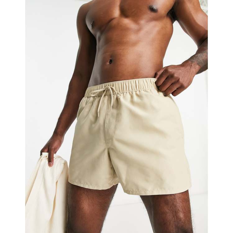 ASOS DESIGN pleated shorts in mid length in beige