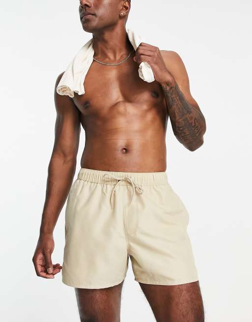 ASOS DESIGN swim shorts in short length in beige