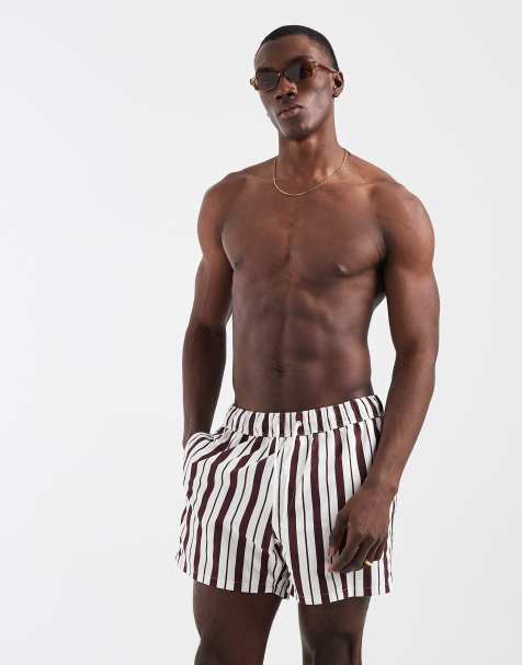 ASOS DESIGN swim shorts in short length in burgundy and white stripe - view 1