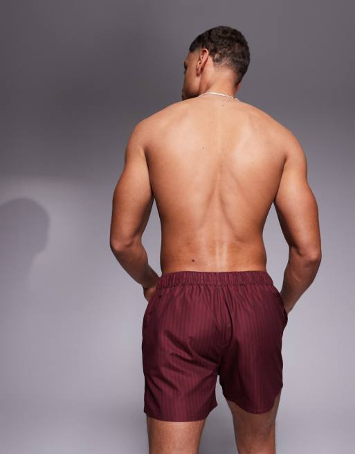 ASOS DESIGN swim shorts in short length in burgundy stripe with placement print, 4 of 4