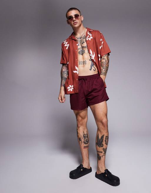 ASOS DESIGN swim shorts in short length in burgundy
