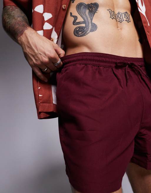 ASOS DESIGN swim shorts in short length in burgundy