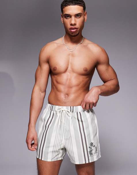 ASOS DESIGN swim shorts in short length in cream stripe with placement print - view 1