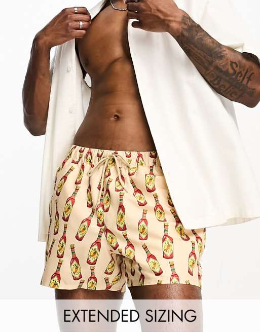 ASOS DESIGN swim shorts in short length with tequila print in beige - part  of a set