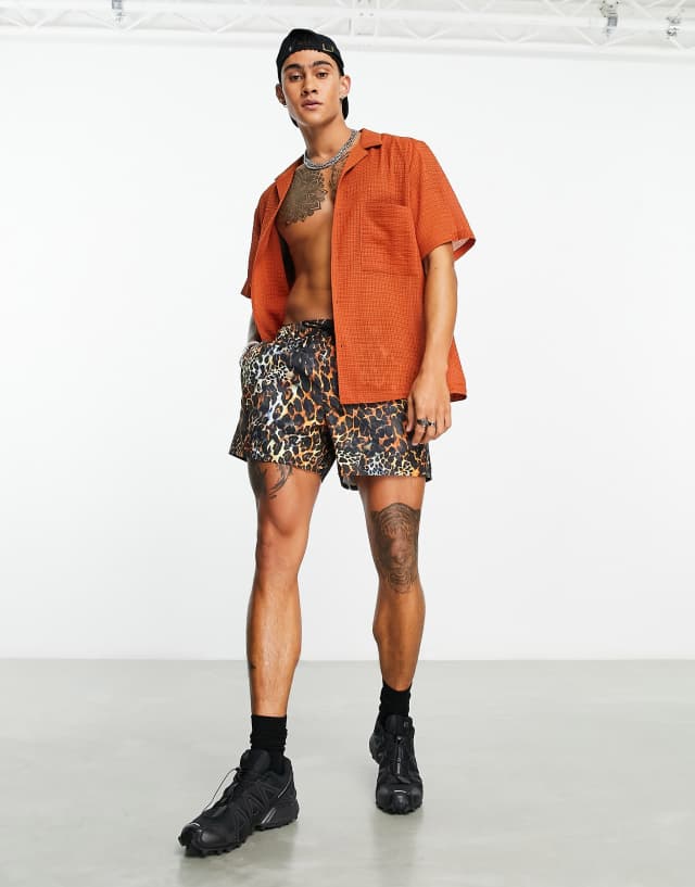 ASOS DESIGN swim shorts in short length in leopard print