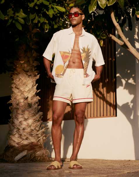 ASOS DESIGN swim shorts in short length in neutral with placement embroidery - view 1