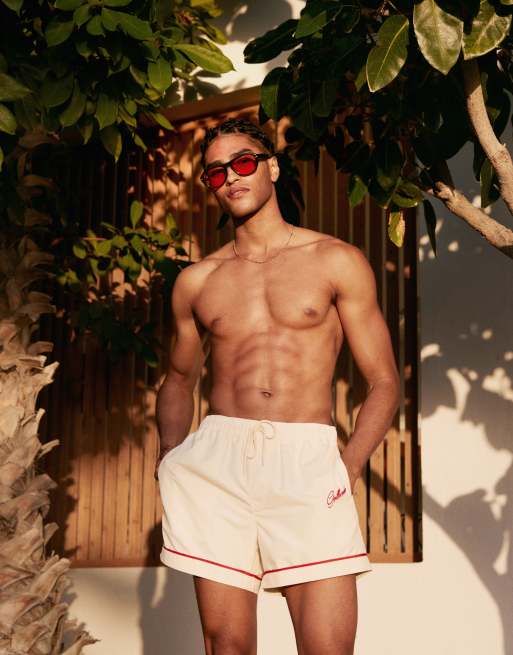 ASOS DESIGN swim shorts in short length in neutral with placement embroidery